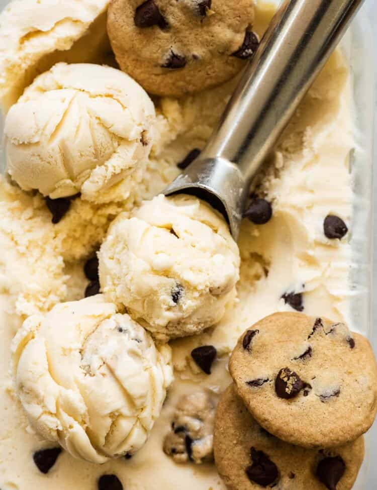 Chocolate Chips Cookie Dough Ice Cream with an ice cream scoop and three cookies.