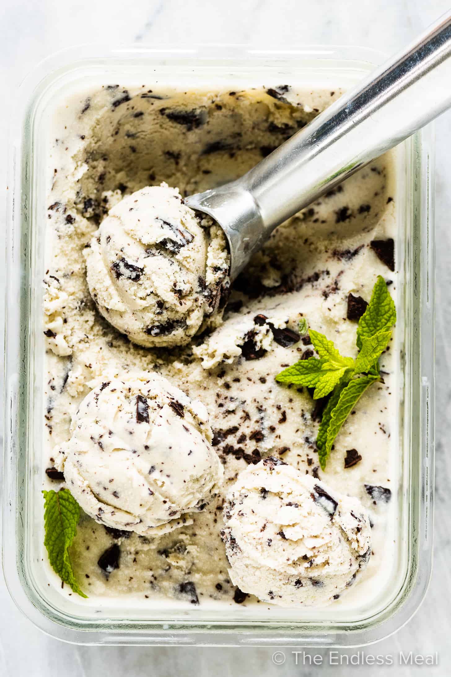 homemade mint ice cream in a freezer container. 