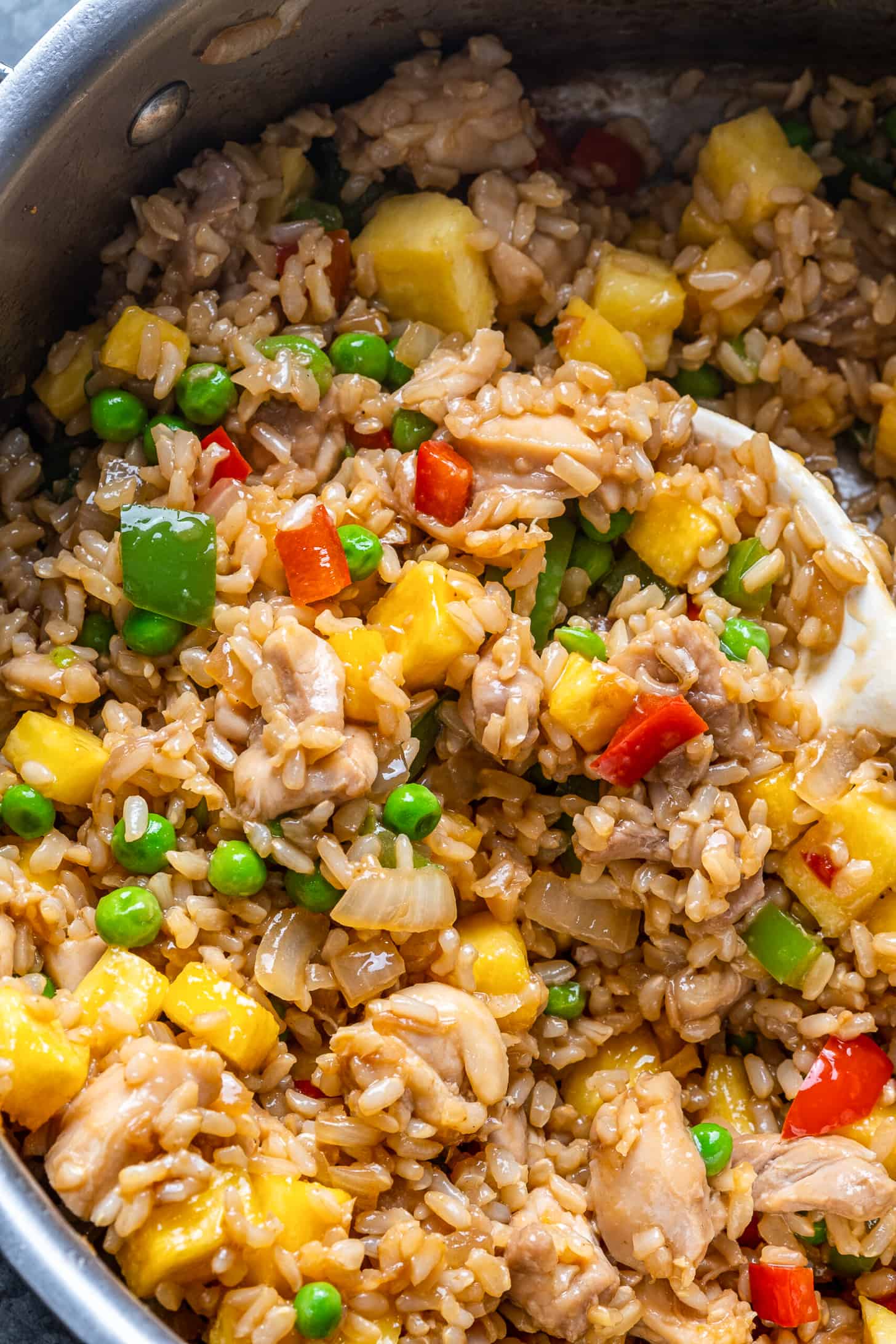 A close up of pineapple fried rice in a wok.