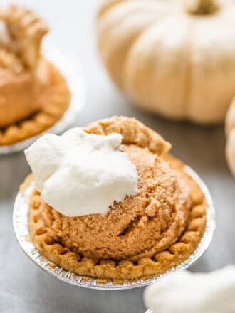 Pumpkin Pie Ice Cream in tart shells with white pumpkins in the background.