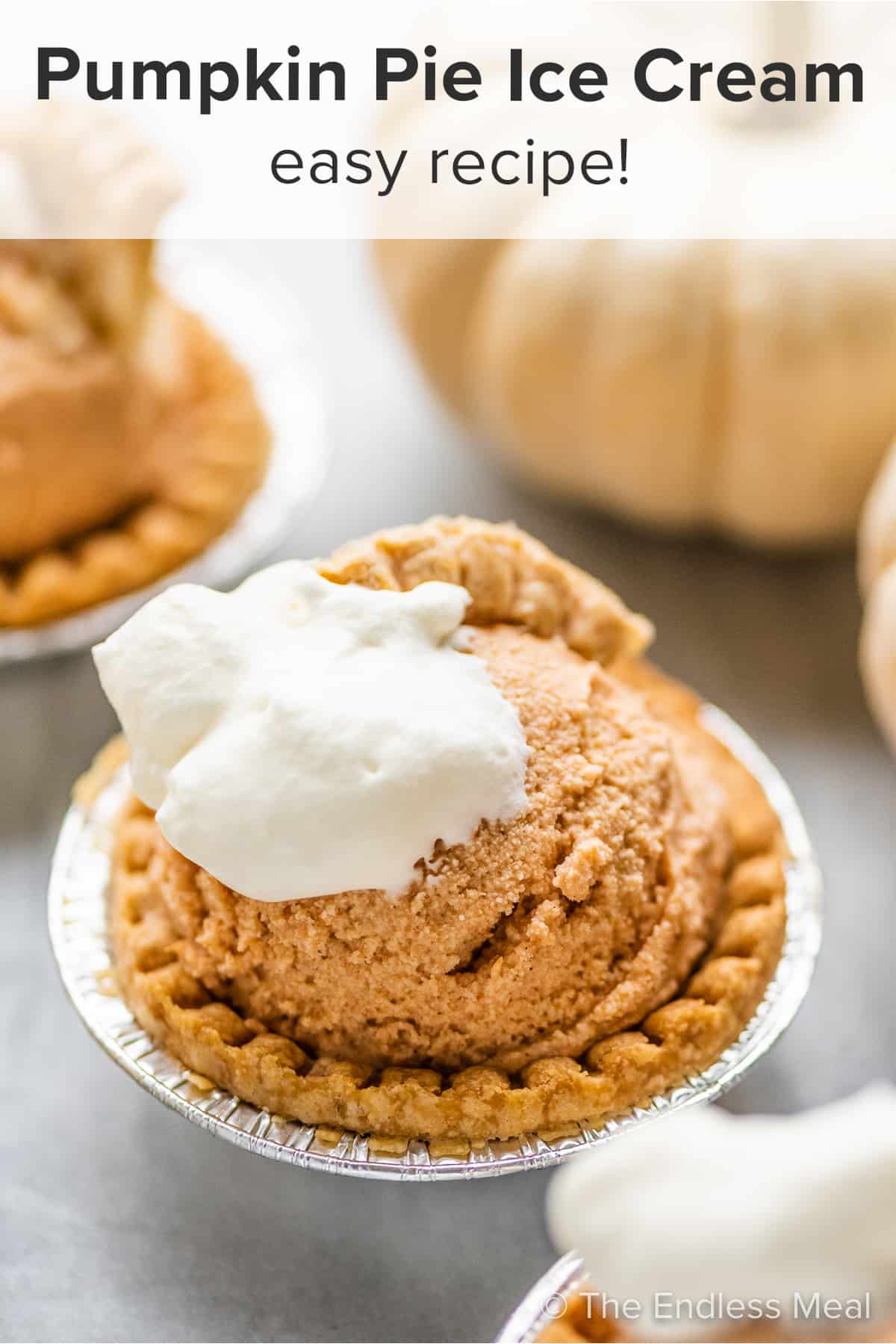 Pumpkin Pie Ice Cream in tart shells with white pumpkins in the background and the recipe title on top of the pciture.