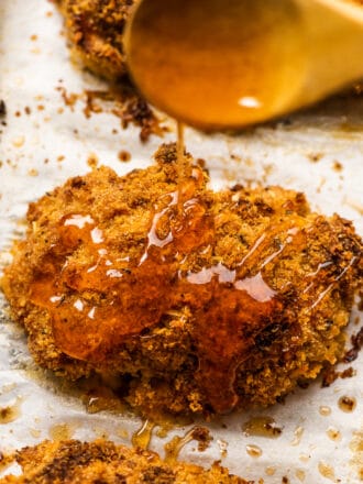 Hot honey being drizzled over crispy chicken.