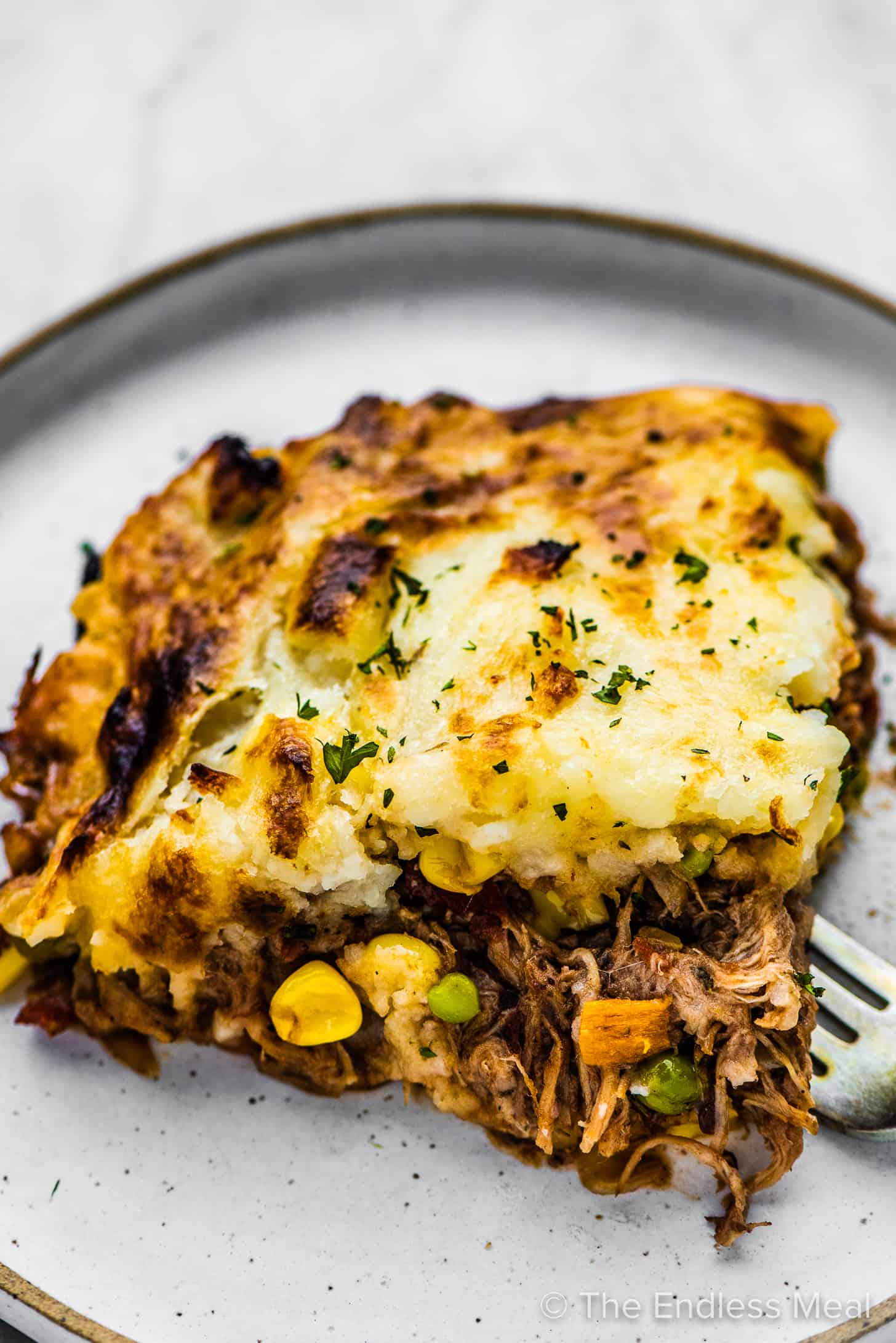 Pulled Pork Shepherd's Pie on a plate with a fork.