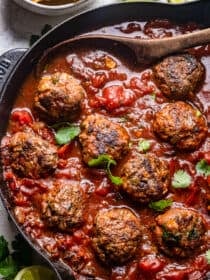 Tex-Mex Meatballs in a tomato sauce in a skillet.