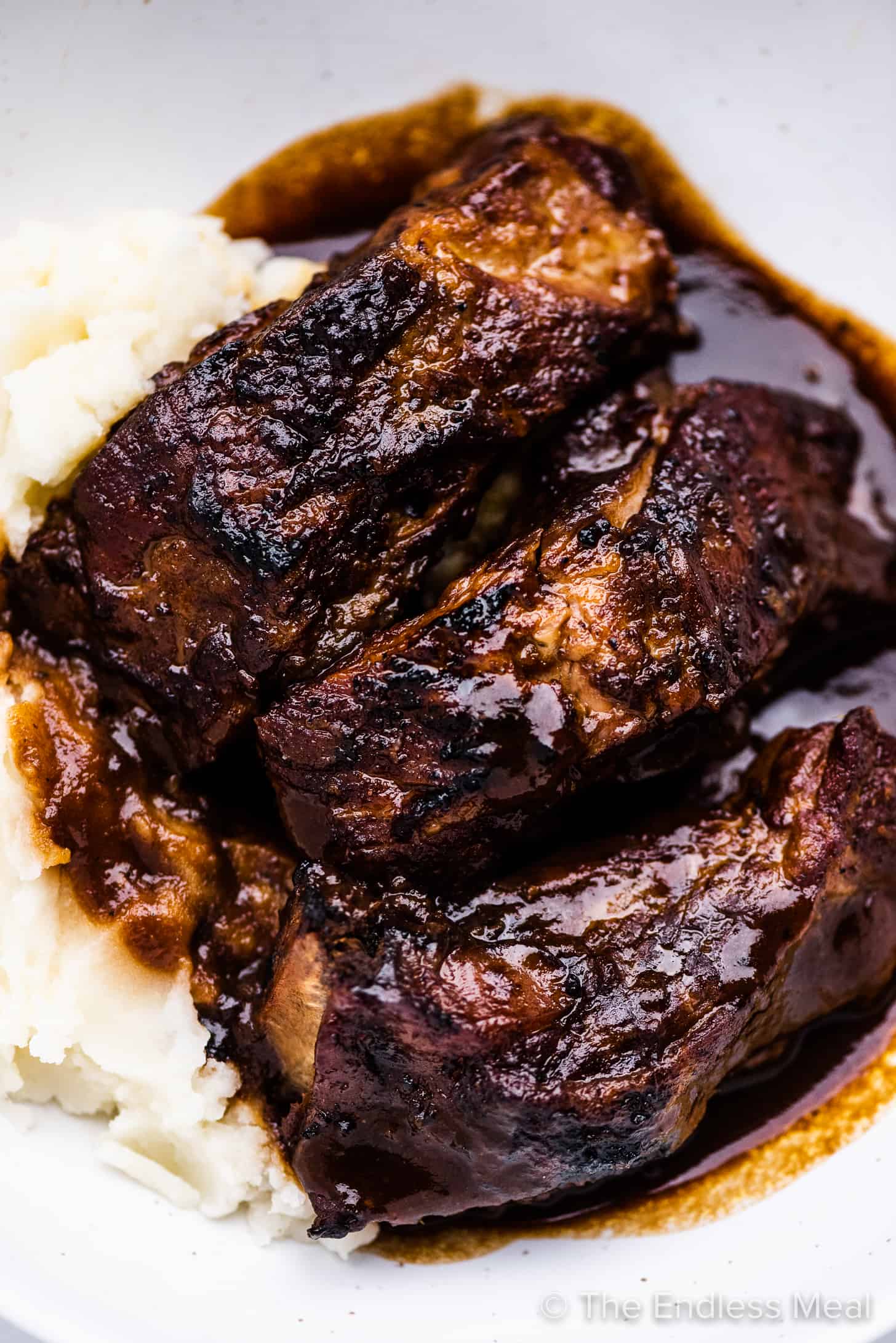 Braised pork ribs on mashed potatoes with gravy.