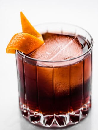 A Coffee Negroni in a rocks glass with an orange peel.