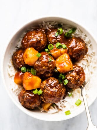 Pineapple Meatballs in a white bowl with rice.
