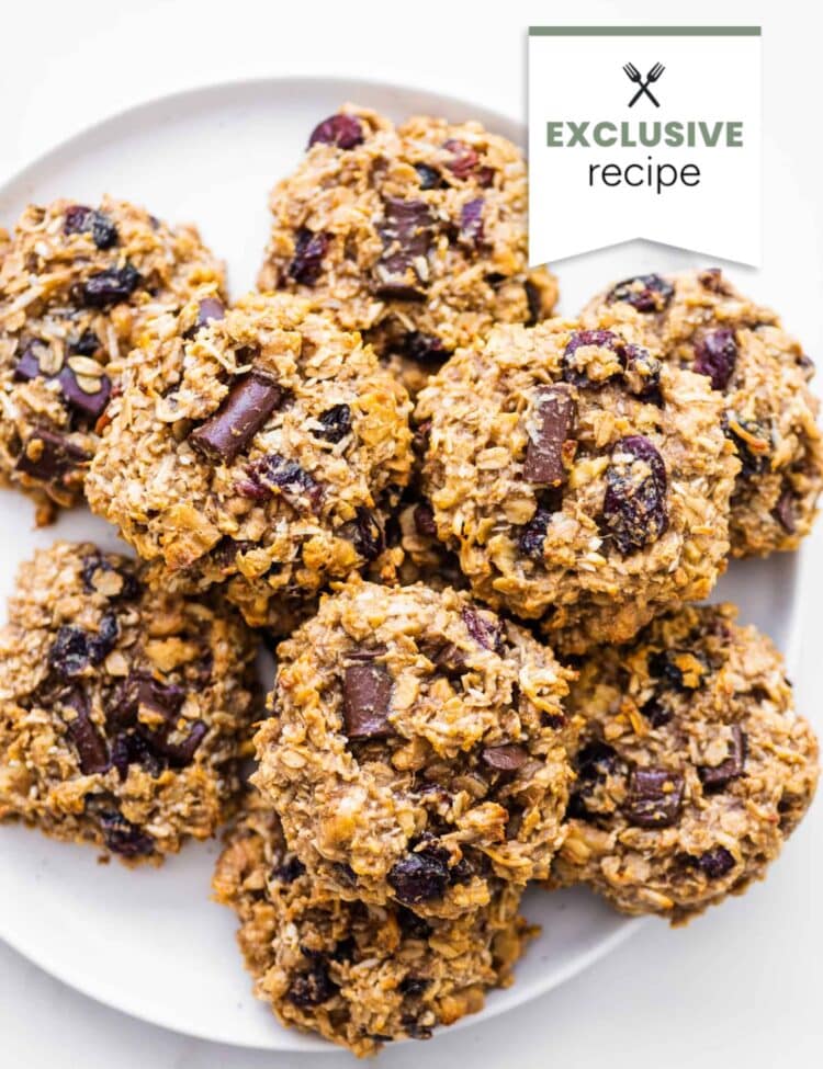 A plate of homemade Breakfast Cookies with visible chunks of chocolate and dried fruit, viewed from above. A label in the corner reads Exclusive recipe.