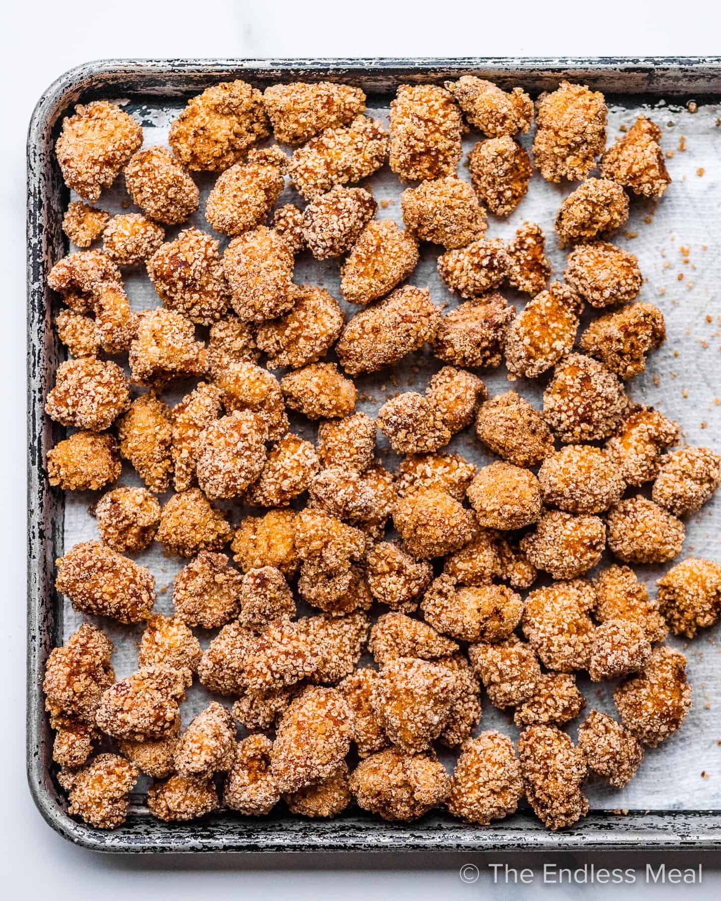 Fried Chicken Bites on a paper towel lined baking sheet.