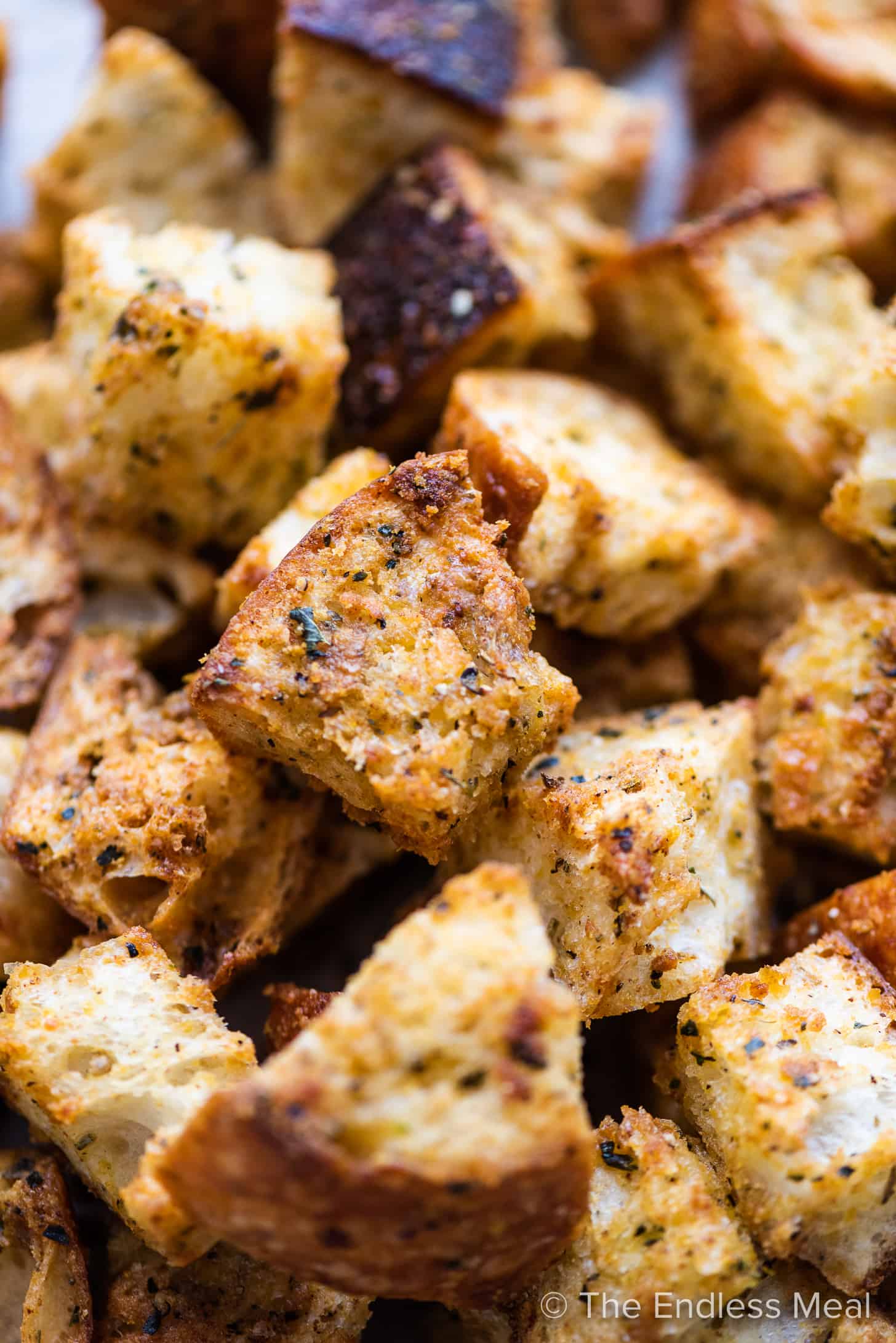 a close up of cheesy garlic parmesan croutons in a pile