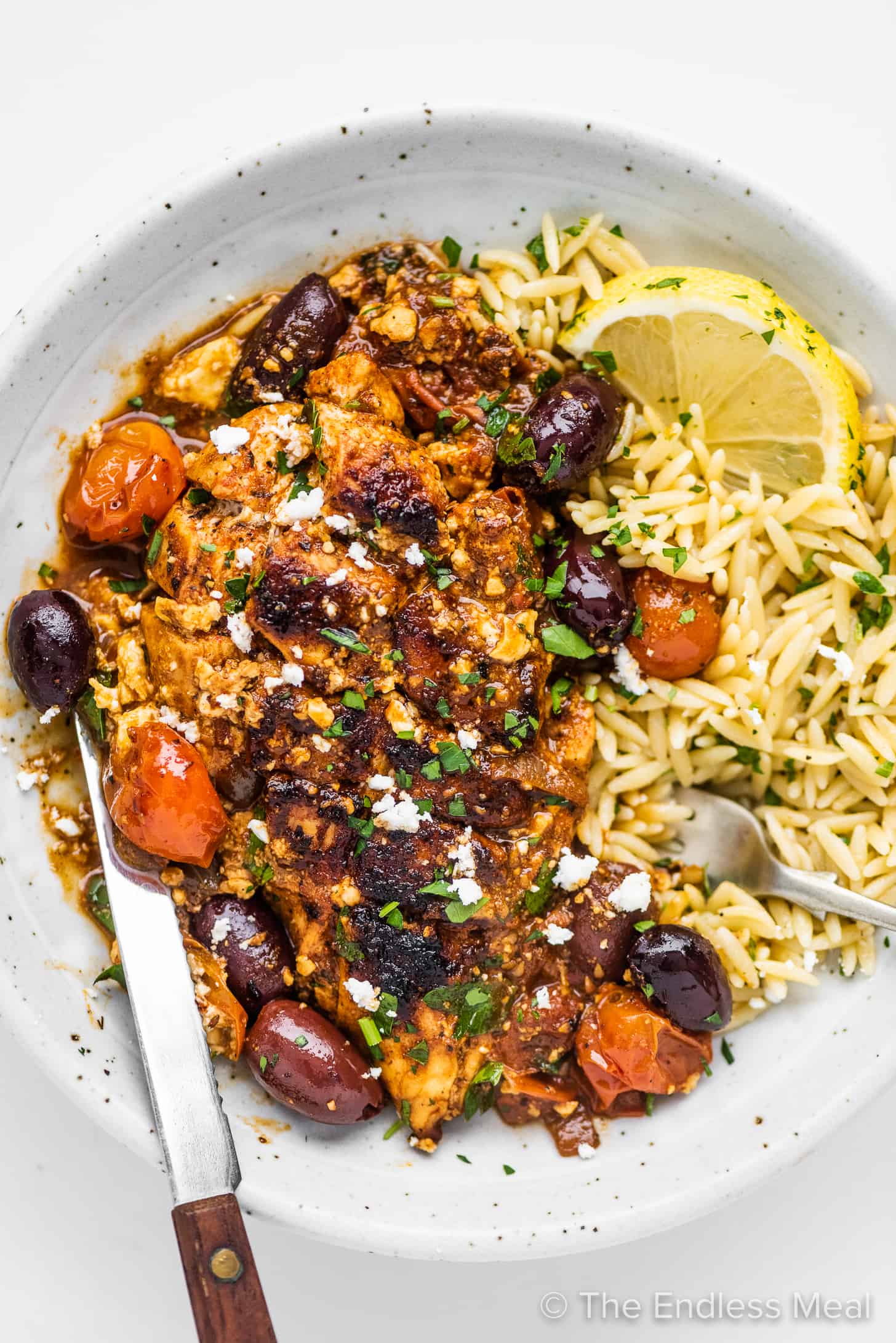 This Greek Chicken Skillet dinner served on a plate with orzo. 