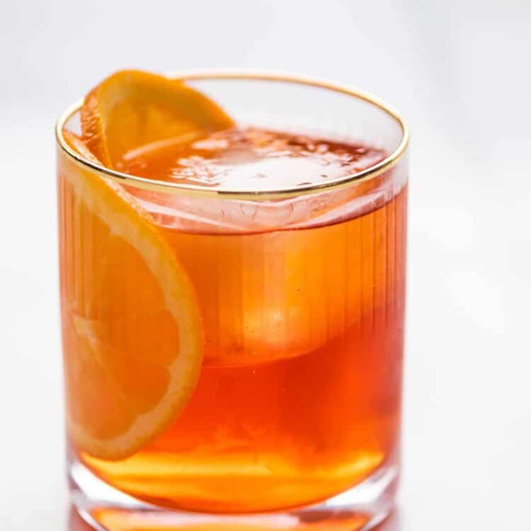 a glass of Aperol Negroni with an orange slice