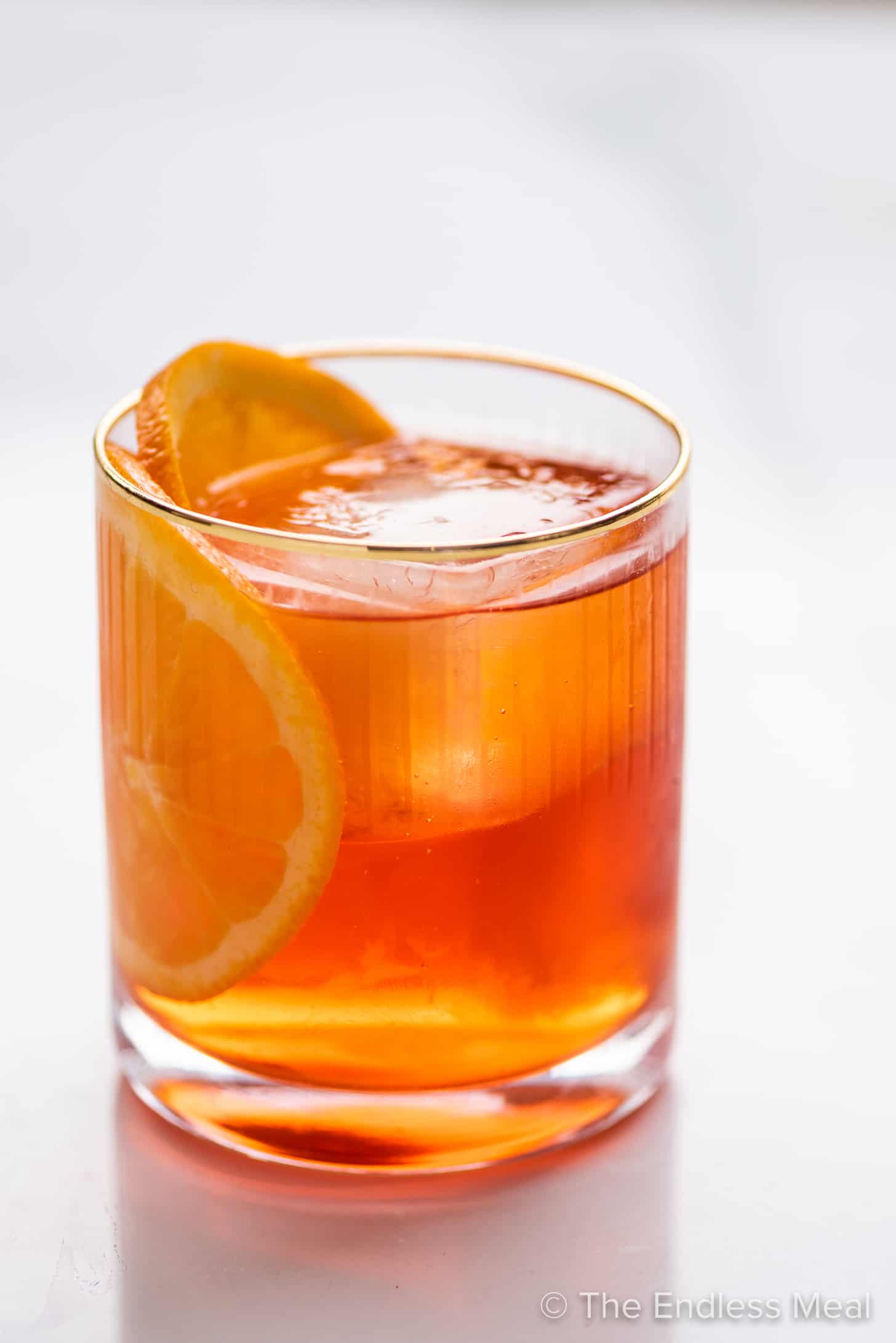 a glass of Aperol Negroni with an orange slice