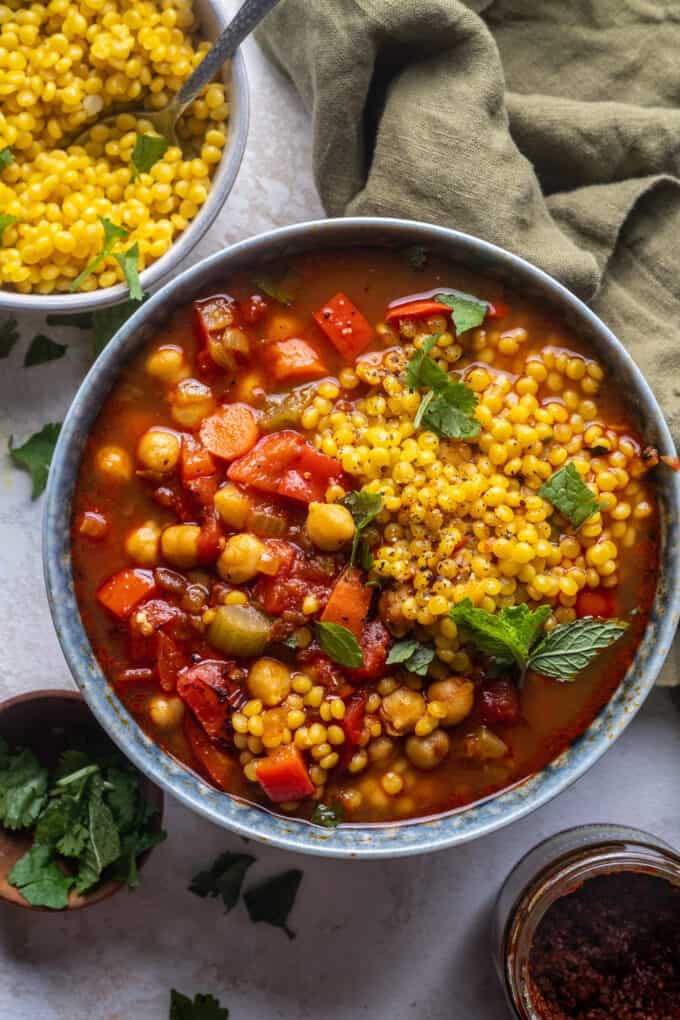 chickpea harissa soup with couscous in a bowl.