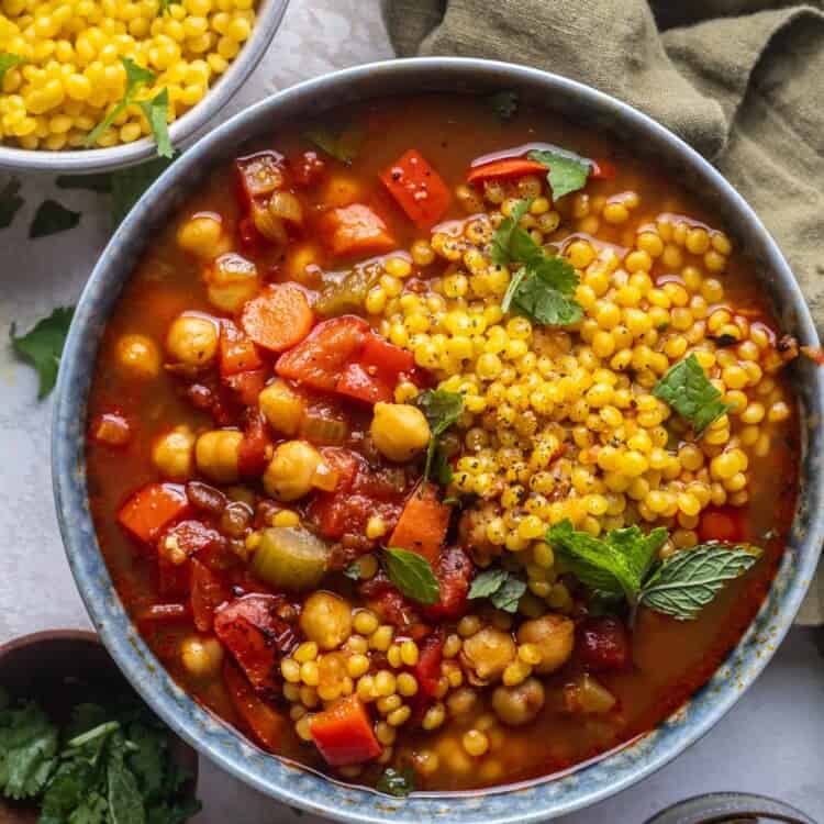 chickpea harissa soup with couscous in a bowl.