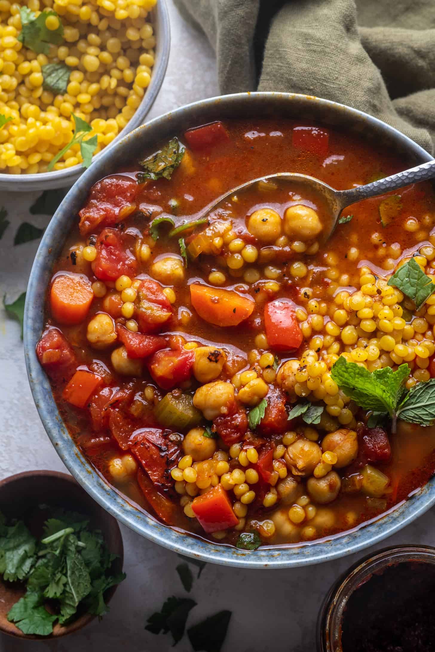 Chickpea Harissa Soup in a bowl with a spoon