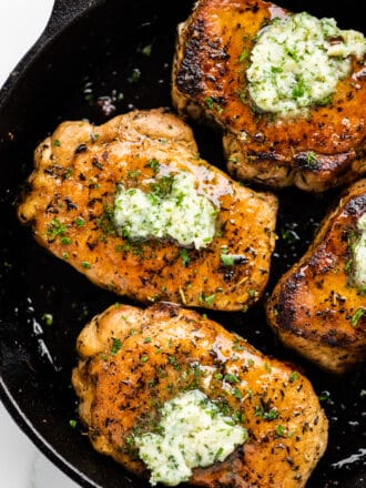 Pan Fried Pork Chops with honey garlic herb butter on top.