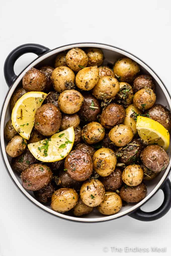 Roasted mini potatoes in a serving dish with lemon