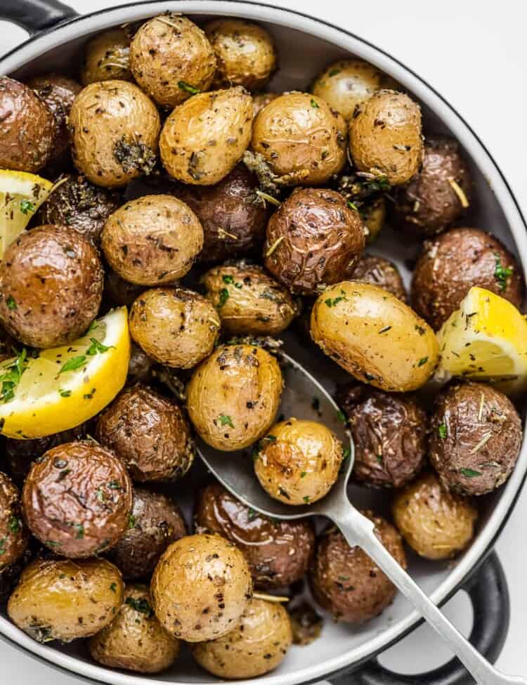 A close up of mini roasted potatoes in a serving dish