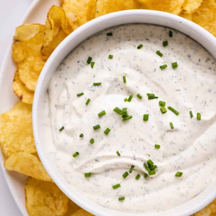 Easy Chip Dip on a plate with chips.