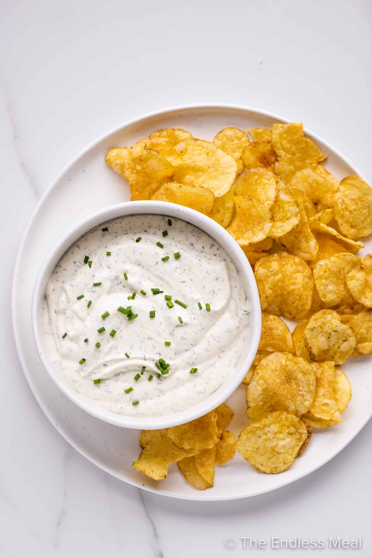 Best Easy Chip Dip on a plate with chips