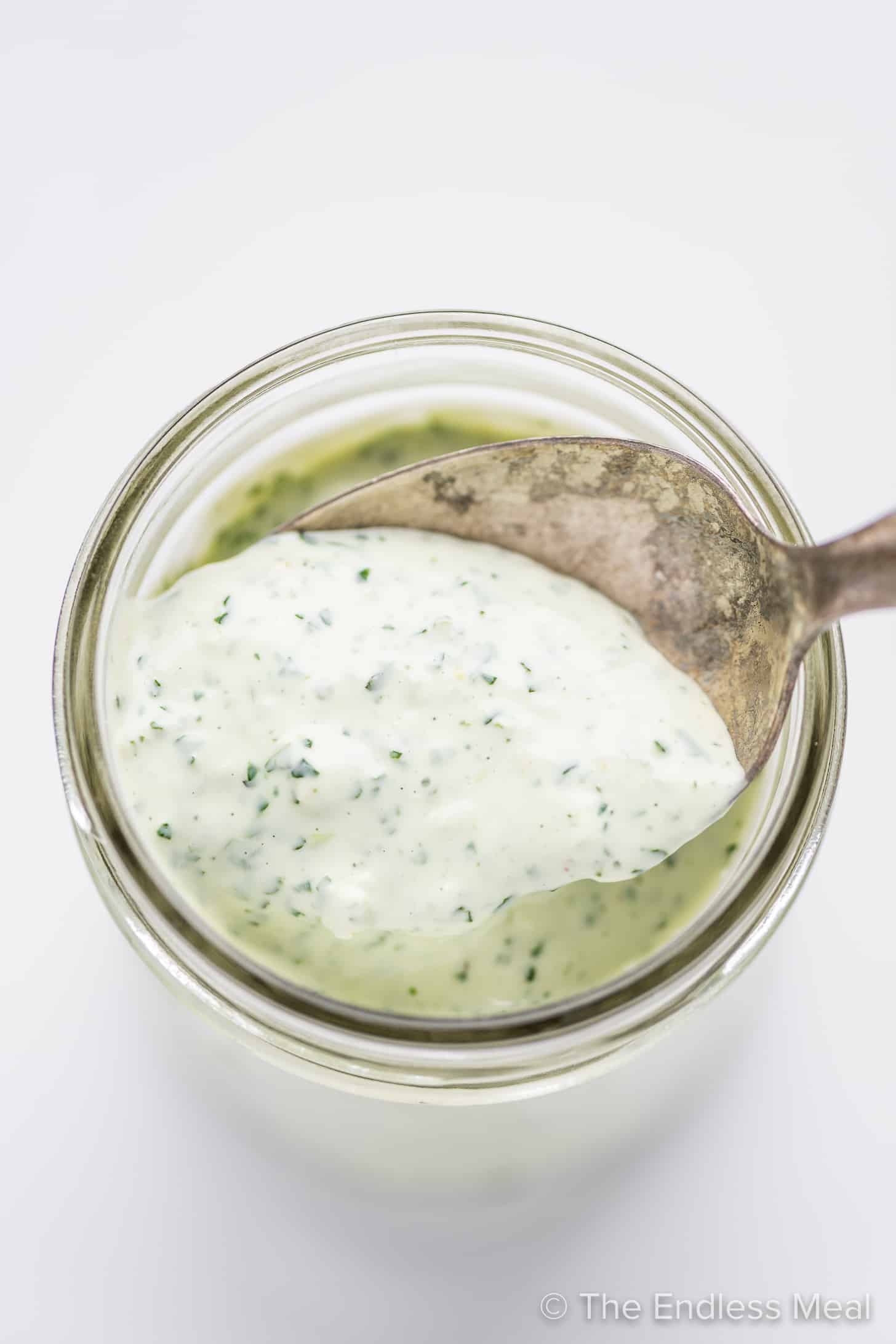 a jar filled with cilantro lime cream sauce