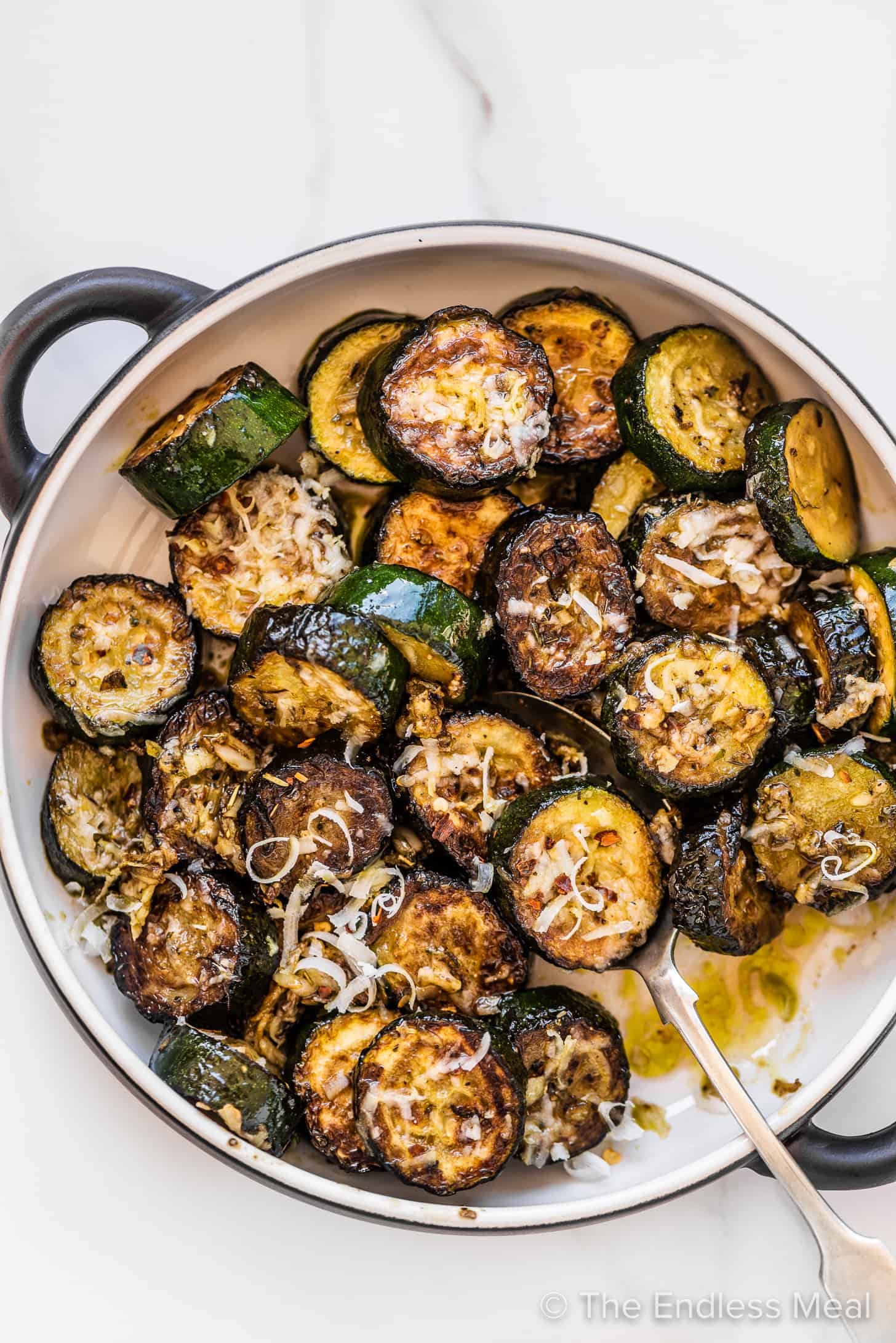 a serving dish with garlic parmesan zucchini rounds. 