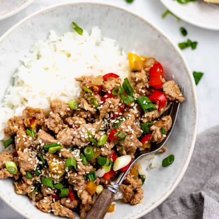 a white bowl with ground turkey stir fry and rice