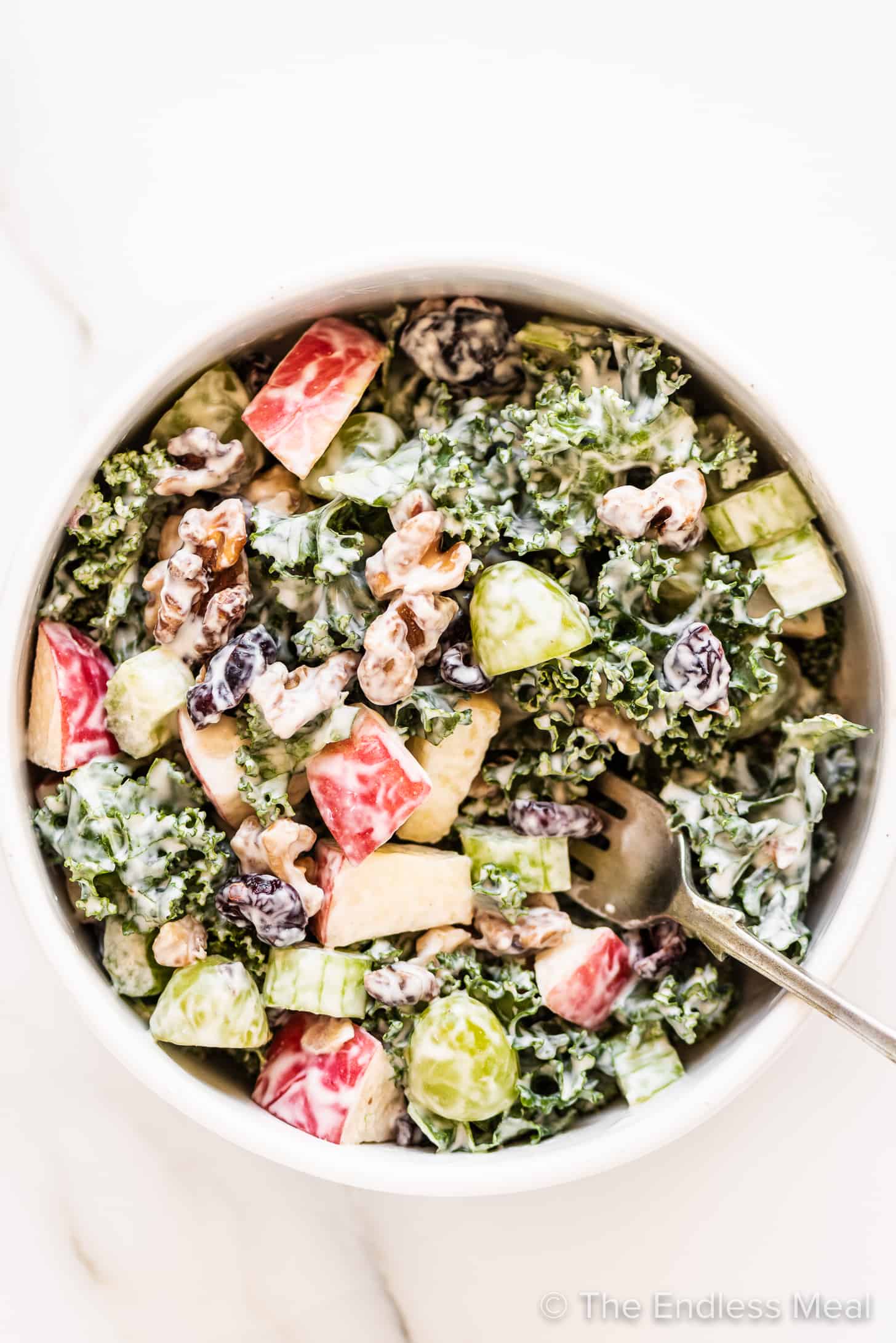 Kale Waldorf Salad in a bowl with a fork