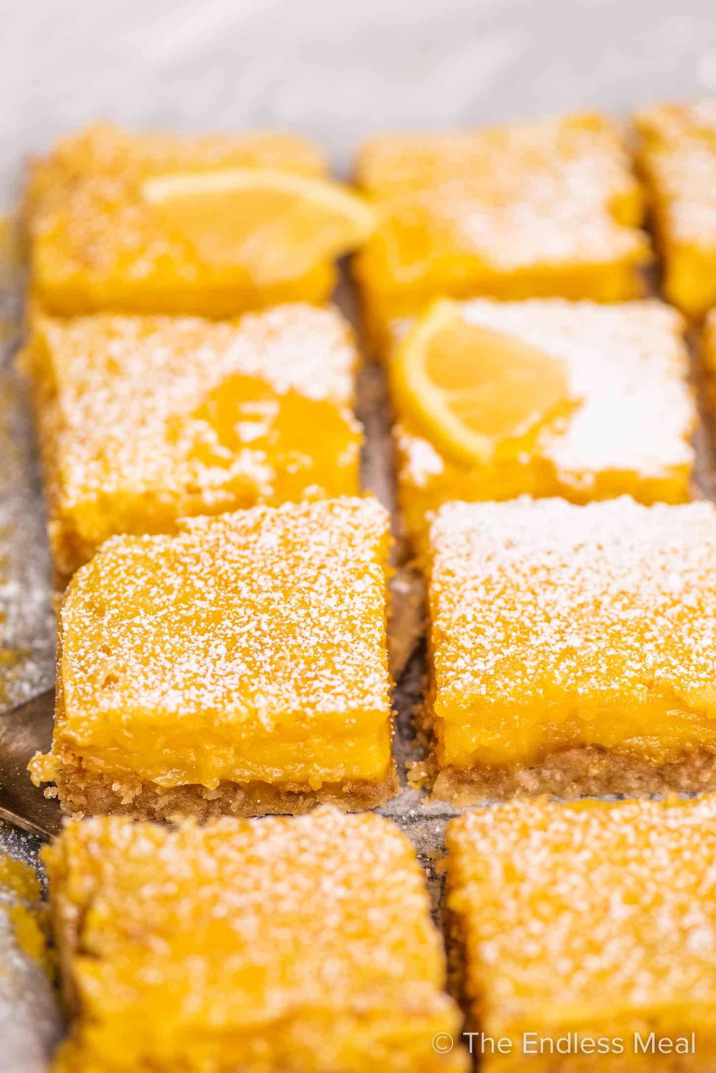 a close up of lemon bars with coconut crust