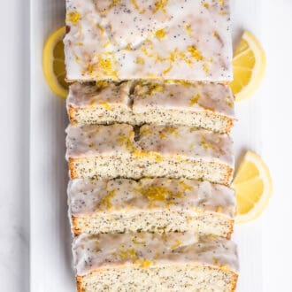 a glazed loaf of lemon banana bread with poppy seeds