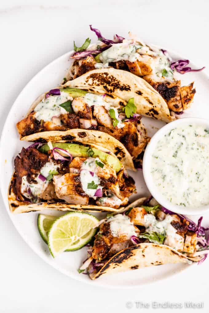 rockfish tacos on a plate with cilantro lime tartar sauce