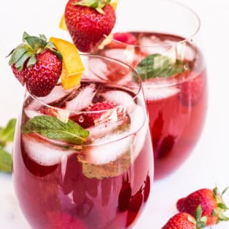 rosé sangria in glasses garnished with strawberries and oranges