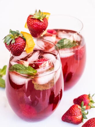rosé sangria in glasses garnished with strawberries and oranges
