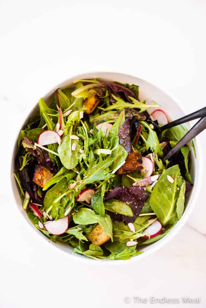 spring mix salad in a white bowl