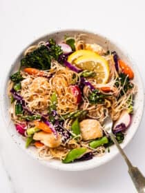 spring vegetable noodle stir fry in a bowl with a fork.