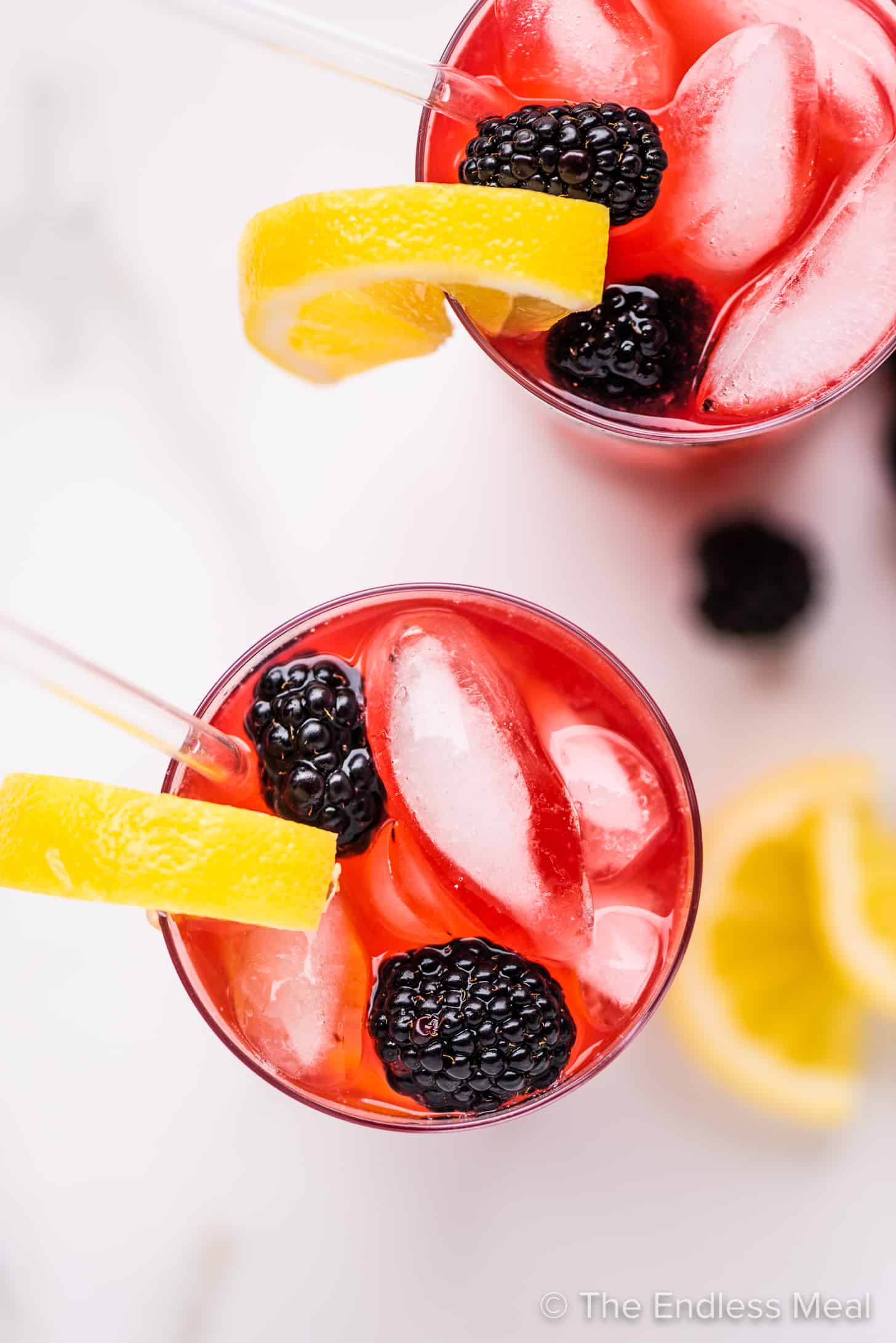 looking down on 2 glasses of lemonade with blackberries