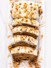 looking down on slices of carrot cake banana bread with cream cheese frosting