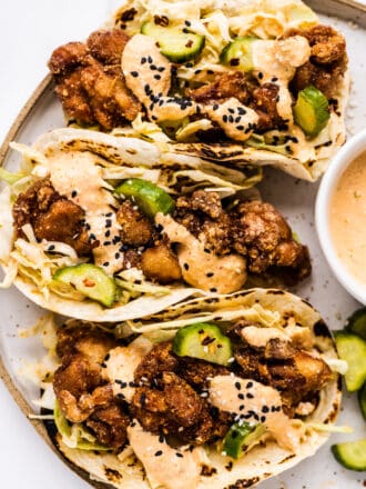 a close up of chicken karaage tacos on a plate