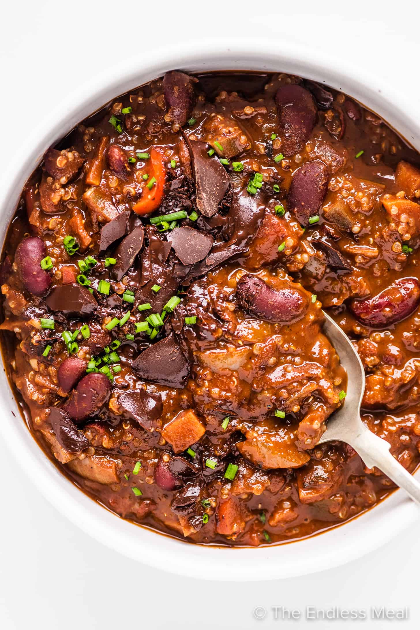 chocolate quinoa chili in a bowl with a spoon