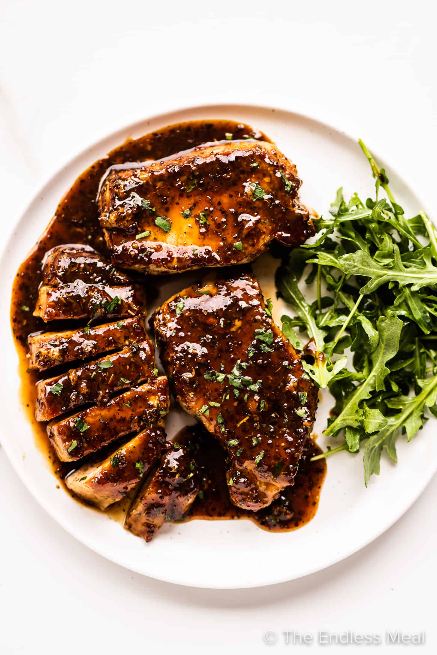 honey mustard pork chops on a plate with salad.