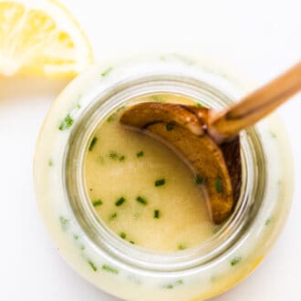 Lemon Salad Dressing in a jar with lemons on the side