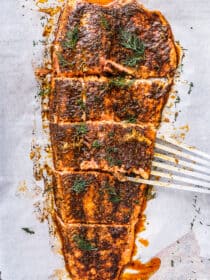 slow roasted salmon cut into pieces on a baking sheet
