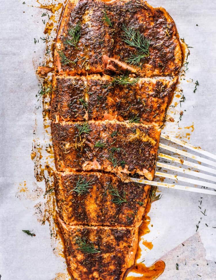 slow roasted salmon cut into pieces on a baking sheet