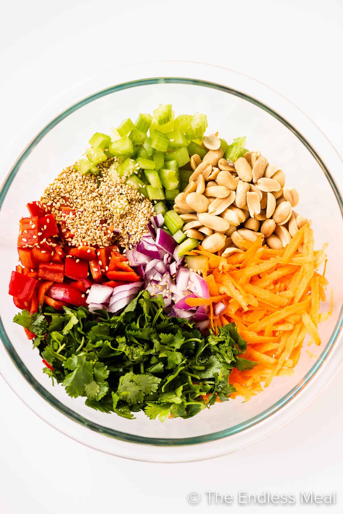 the ingredients for this Asian Salad Recipe in a glass bowl