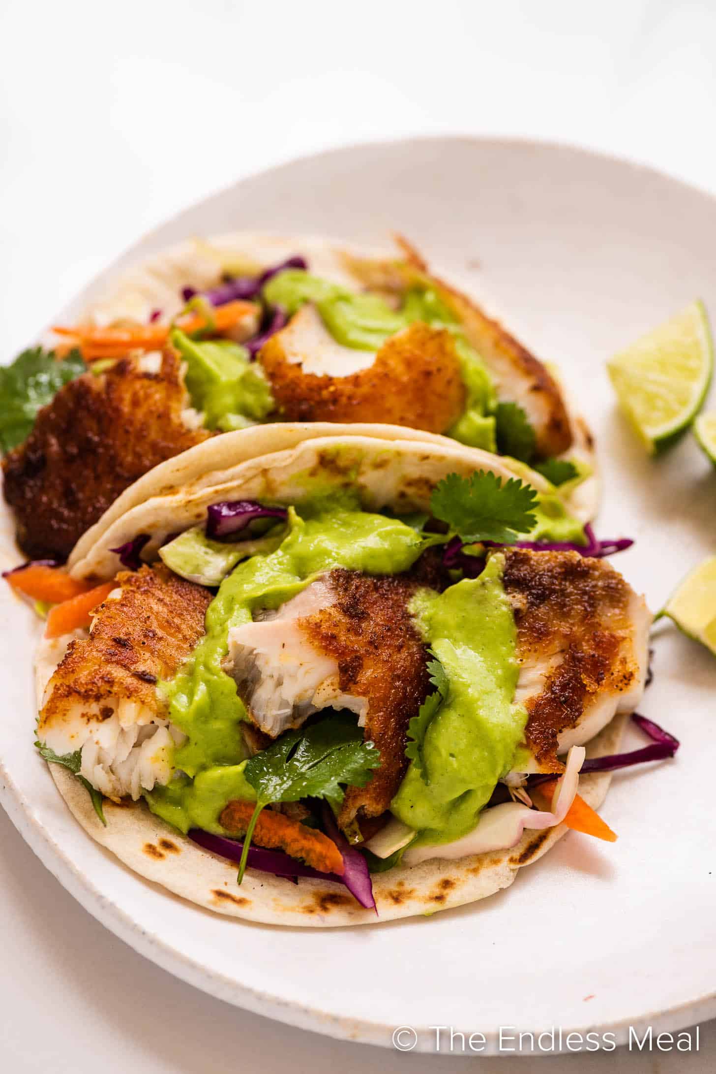 a close up of Baja Fish Tacos on a white plate