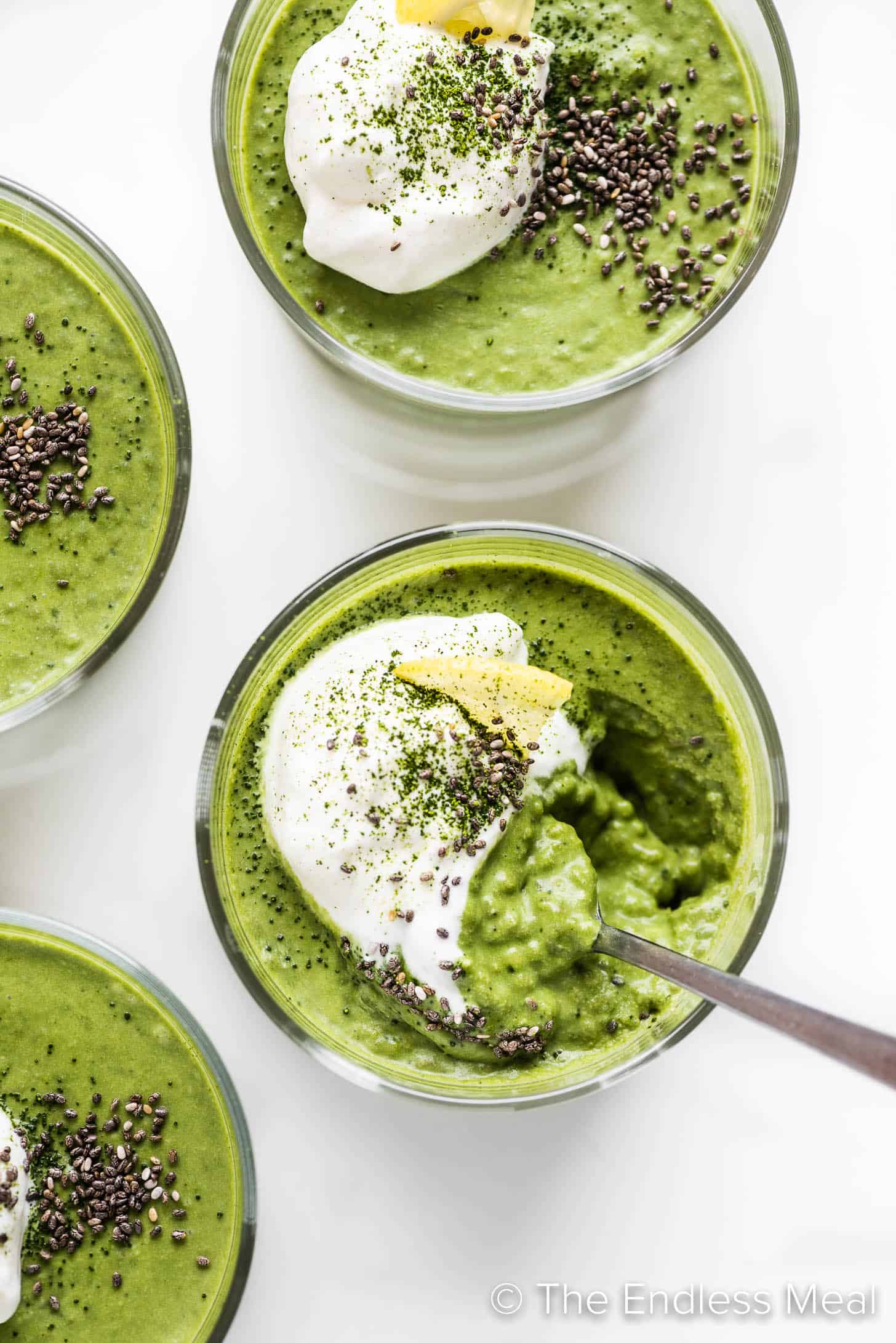 chia matcha pudding with a spoon taking a scoop