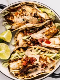 Grilled Fish Tacos on a plate with limes on the side