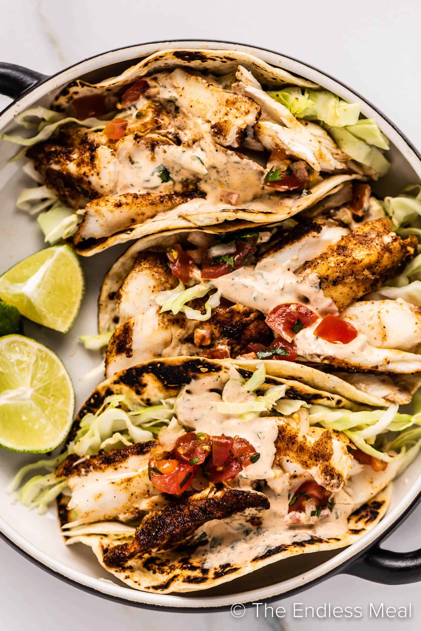 Grilled Fish Tacos on a plate with limes on the side