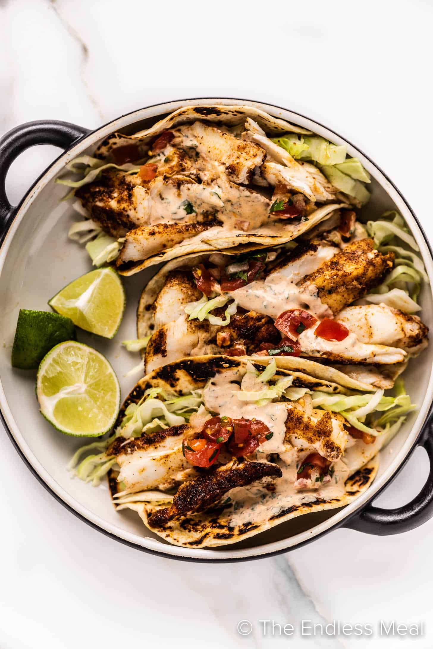 three Grilled Fish Tacos on a plate